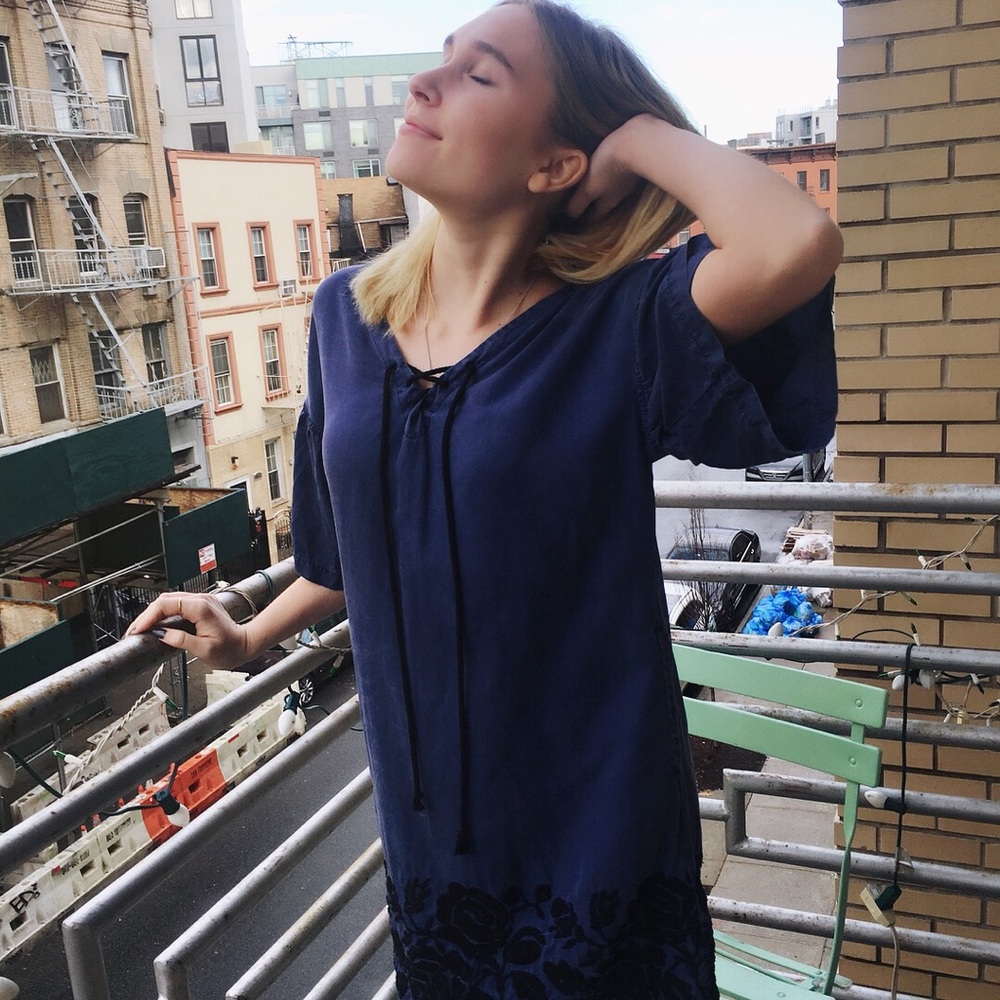 Blue dress. Loose fitting. Black embroidery.